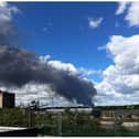 Dozens of fire fighters are tackling the blaze which involves hundreds of tyres.