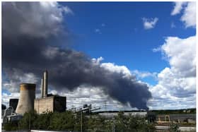 Dozens of fire fighters are tackling the blaze which involves hundreds of tyres.