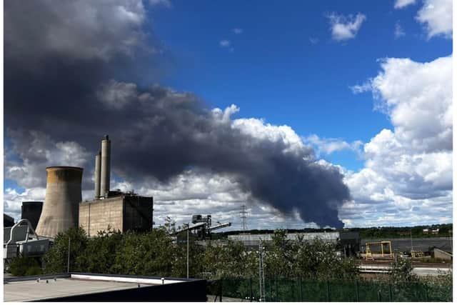 Dozens of fire fighters are tackling the blaze which involves hundreds of tyres.