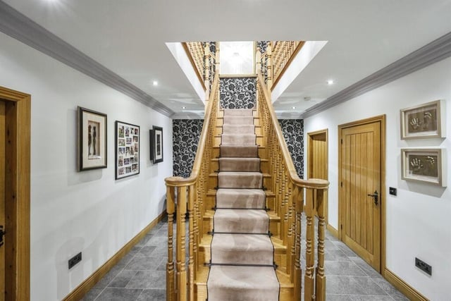 The oak staircase rises to a gallery landing from the hallway.
