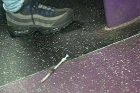 The syringe on the floor of the school bus.