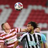 Jack Goodman battles for the ball against Newcastle United in the Papa Johns Trophy.