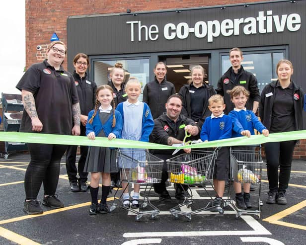 Schoolchildren from Tickhill St Mary's CofE Primary and Nursery School join the Central England Co-op team to cut the ribbon on the brand new store