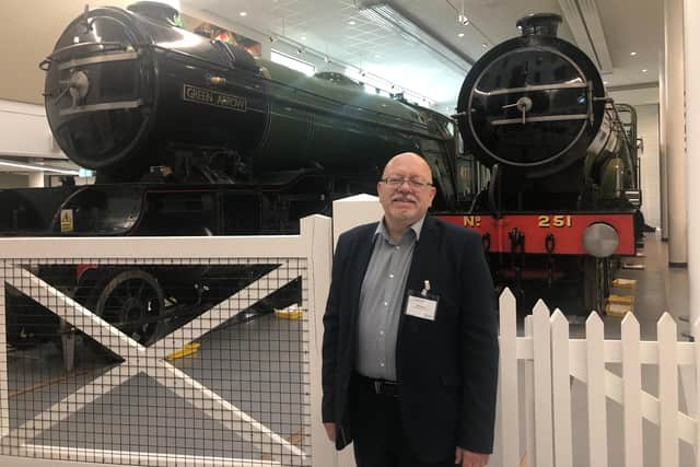 Coun Glyn Butcher in front of the locomotives.