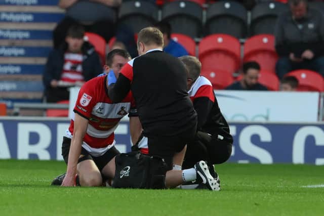 Doncaster's Tom Anderson receives treatment against Mansfield Town.