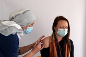 Emma Smith, Nurse Practitioner, pictured administering first dose vaccinations at Jamia Mosque pop-up clinic in Hyde Park