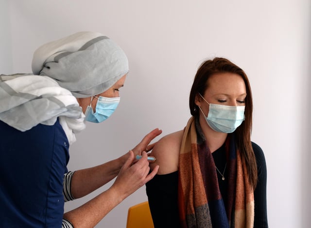 Emma Smith, Nurse Practitioner, pictured administering first dose vaccinations at Jamia Mosque pop-up clinic in Hyde Park