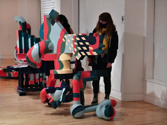 Visitors study as scuplture by Eduardo Paolozzi, Hamlet in a Japanese Manner..