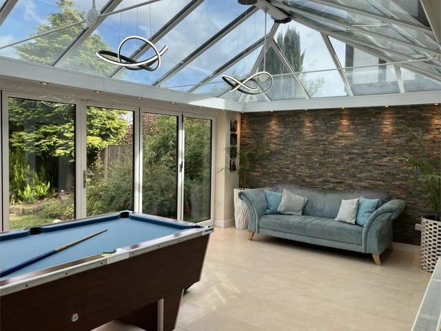 A versatile sun room opens through to the garden.