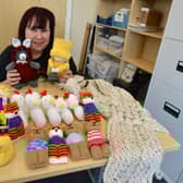 Karen with her knitted creations