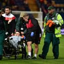 Doncaster Rovers' Louie Marsh is taken off on the stretcher after breaking his arm.