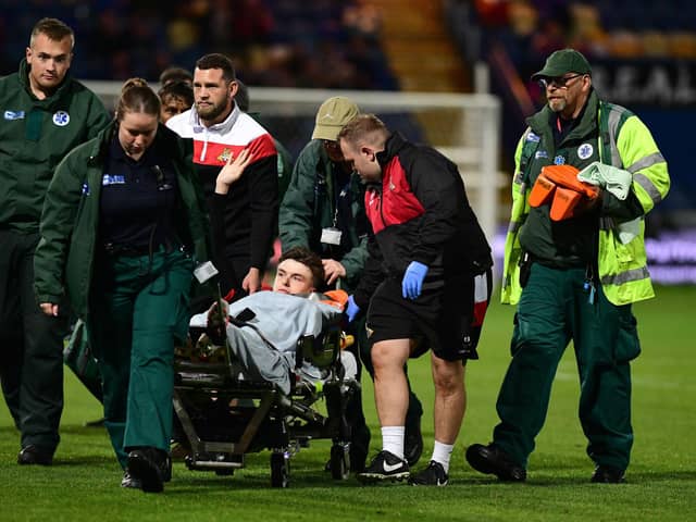 Doncaster Rovers' Louie Marsh is taken off on the stretcher after breaking his arm.