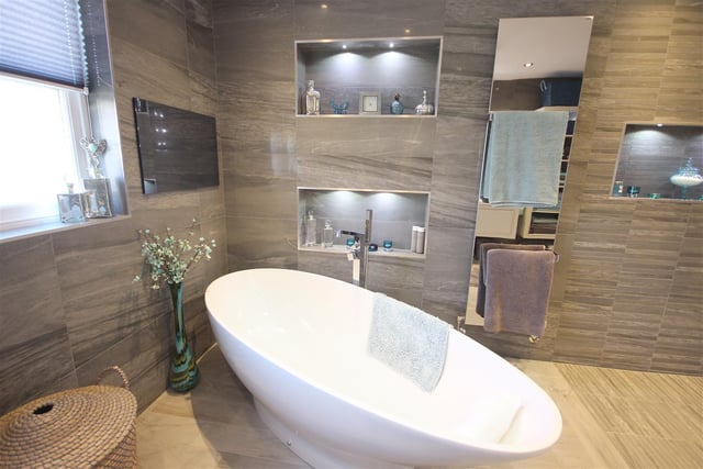 This is the master bedroom en-suite - it contains a freestanding bath and an integrated television.