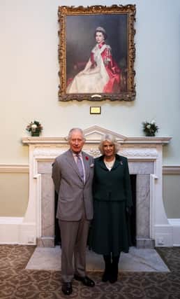 King Charles III and Camilla, Queen Consort, in front of a picture of the late Queen Elizabeth II.  (Photo by Molly Darlington - WPA Pool/Getty Images)