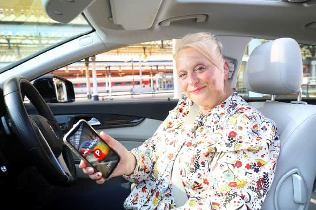 Claire Ansley makes a contactless payment for car parking  at the railway station.