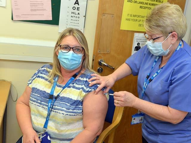 Karen Ford, A Sheffield health and social care worker receiving the vaccine from Janice Wake, health care assistant at Sheffield Vaccination centre at Matthews Practice.