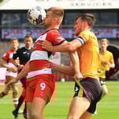 Doncaster Rovers' George Miller shields the ball from Newport County's Ryan Delaney.