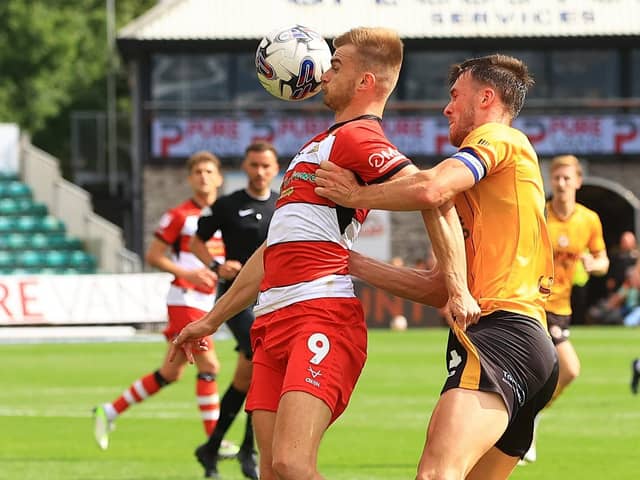 Doncaster Rovers' George Miller shields the ball from Newport County's Ryan Delaney.