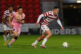Luke Molyneux gets on the ball for Doncaster Rovers.