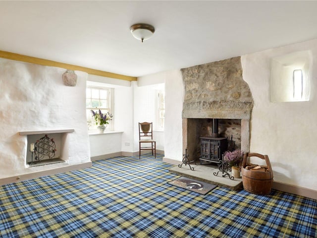 This lounge has a wood burning stove and several windows, including a shot-hole window discovered during the refurbishments in 2000.