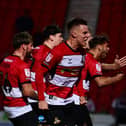 Doncaster Rovers' players celebrate their second goal against Mansfield Town.