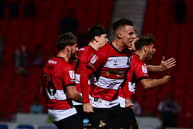 Doncaster Rovers' players celebrate their second goal against Mansfield Town.