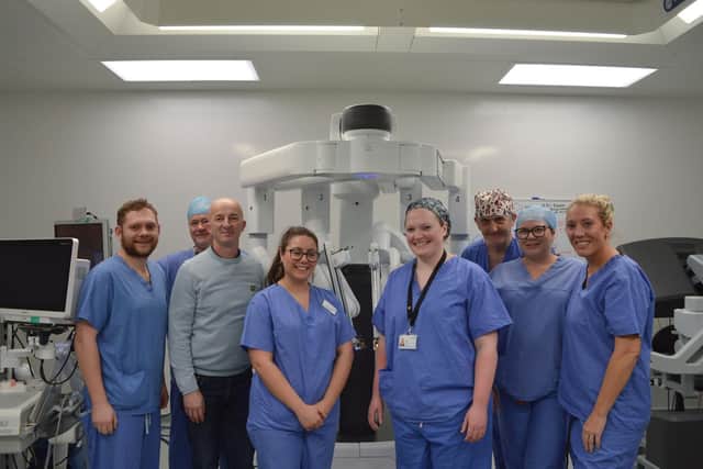Colorectal Robotic Surgery Team and patient Michael pictured with the Da Vinci Surgical XI robot.