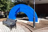 The monument is currently a sky blue arch. Once completed, it will resemble a rainbow