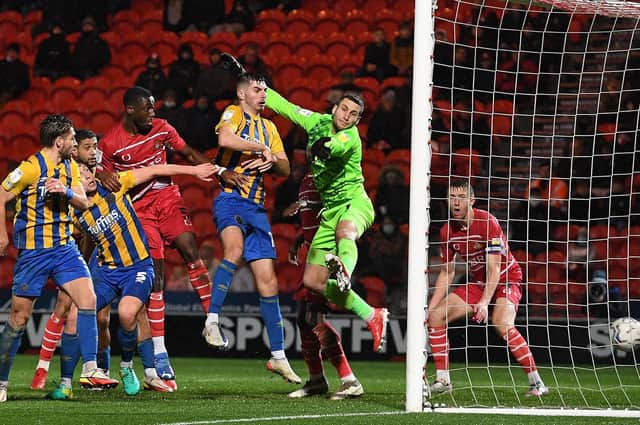 Joseph Olowu heads in the winner against Shrewsbury. Photo: Howard Roe/AHPIX LTD