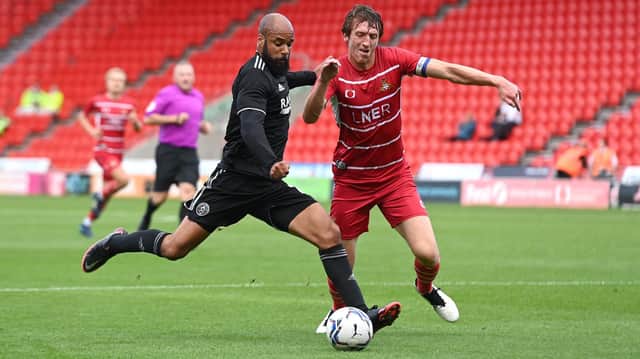 Tom Anderson battles with Sheff Utd's David McGoldrick. Picture: Andrew Roe/AHPIX LTD