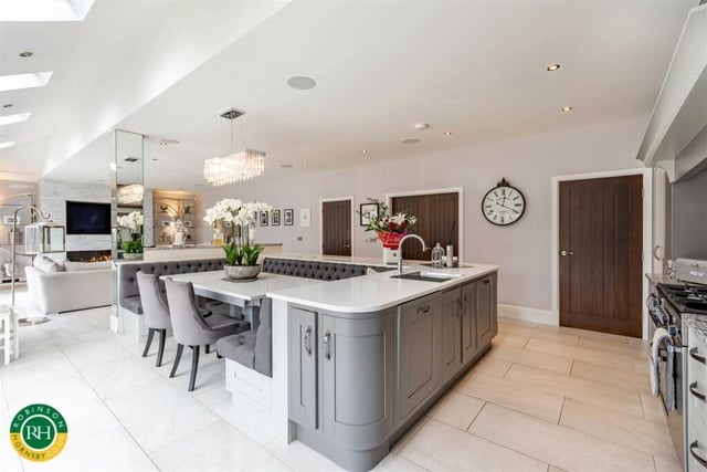 A high spec kitchen with central island and built-in dining area.