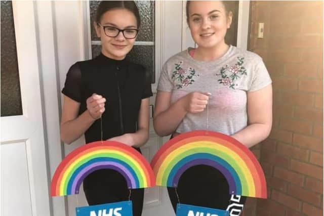 Olivia and Isabelle with their rainbows for the NHS.