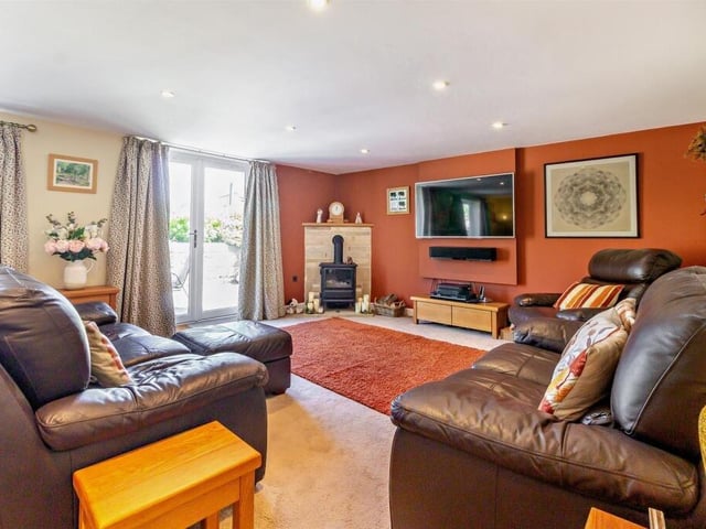 The lounge has a cosy opti-flame stove, and access to the garden.