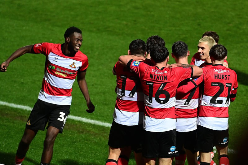 Doncaster's players celebrate Harrison Biggins' goal.