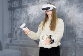 Picture shows the VR equipment being demonstrated.