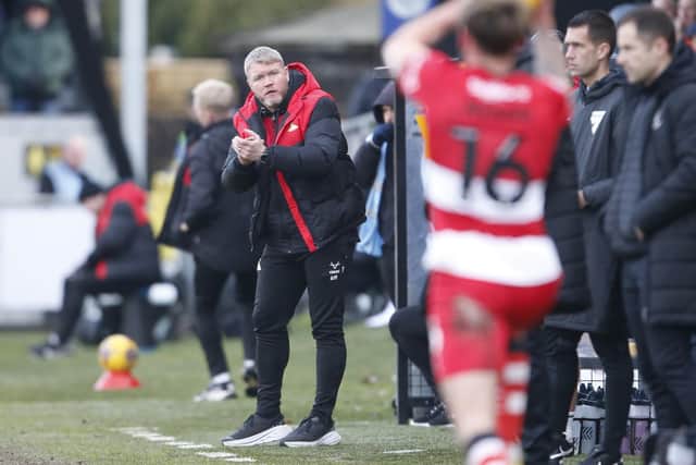 Doncaster Rovers manager Grant McCann encourages his players from the sidelines.