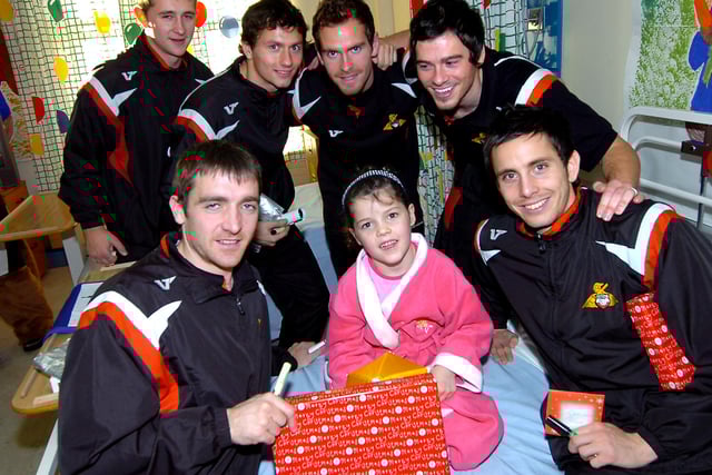 Wade Fairhurst, Jon Spicer, Martin Woods, Gordon Greer, Paul Heffernan and Brian Stock hand over a Christmas present to six-year-old Shelby Pilling of Denaby, during the players visit to Doncaster Royal Infirmary at Christmas 2008