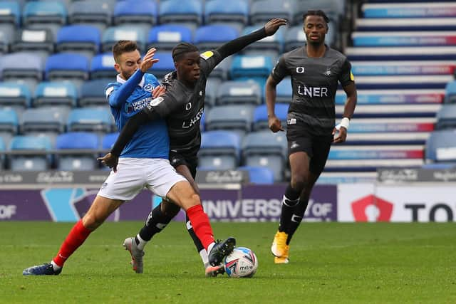 Taylor Richards looks to power past Portsmouth's Ben Close. Picture; Gareth Williams/AHPIX