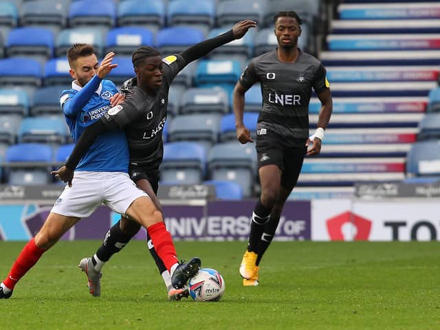 Taylor Richards looks to power past Portsmouth's Ben Close. Picture; Gareth Williams/AHPIX