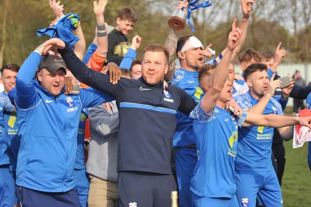 Ben Hunter (centre) celebrates Rossington Main's promotion with his players and assistant Mick Fraser (left). Photo: Russ Sheppard/Offthebenchpics
.