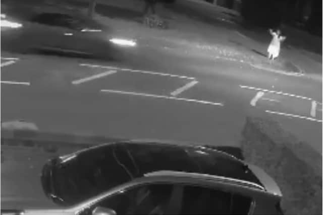 The woman can be seen attempting to stop a car on Armthorpe Road in the CCTV clip.