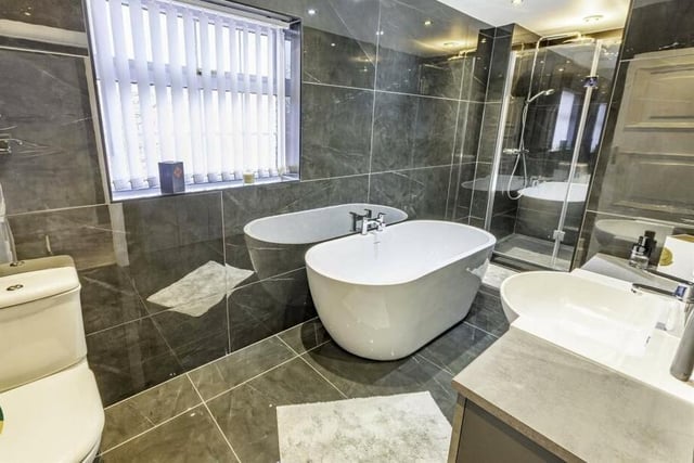 A contemporary style bathroom with freestanding bath and walk-in shower.