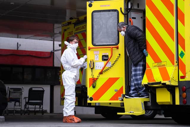 A man with an unknown condition is helped from an ambulance (Photo by Justin Setterfield/Getty Images)