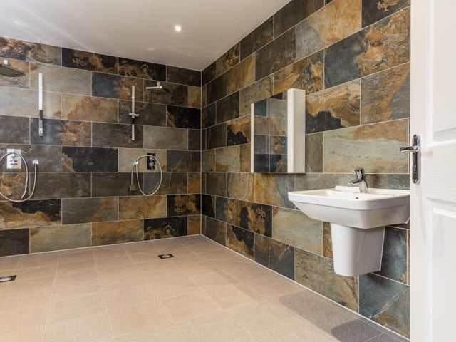 Walk-in showers within the pool complex.