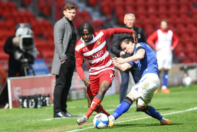 Taylor Richards looks to power past Jake Forster-Caskey with Andy Butler looking on. Picture: Howard Roe/AHPIX