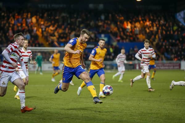 Doncaster Rovers' play-off hopes are fading after a heavy defeat at Mansfield.