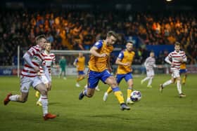 Doncaster Rovers' play-off hopes are fading after a heavy defeat at Mansfield.