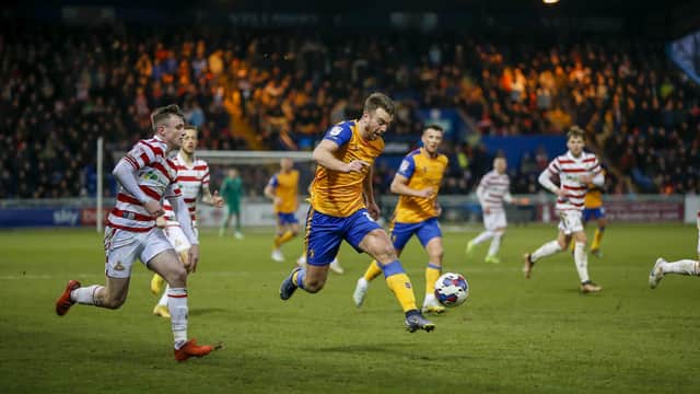 Doncaster Rovers' play-off hopes are fading after a heavy defeat at Mansfield.