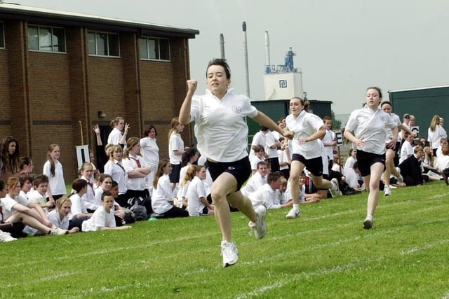 Emily Monk, 12, (front) sets a new school record as she wins the 100m year 7 girls race at a time of 13.75 seconds as other pupils watch at the sports day at Hungerhill School, Edenthorpe, June 15, 2006