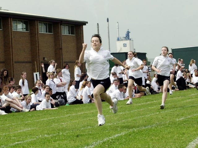 Emily Monk, 12, (front) sets a new school record as she wins the 100m year 7 girls race at a time of 13.75 seconds as other pupils watch at the sports day at Hungerhill School, Edenthorpe, June 15, 2006